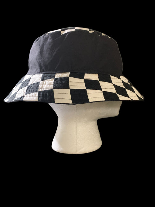 Checkered bucket hat on a mannequin head against a black background. Side view 