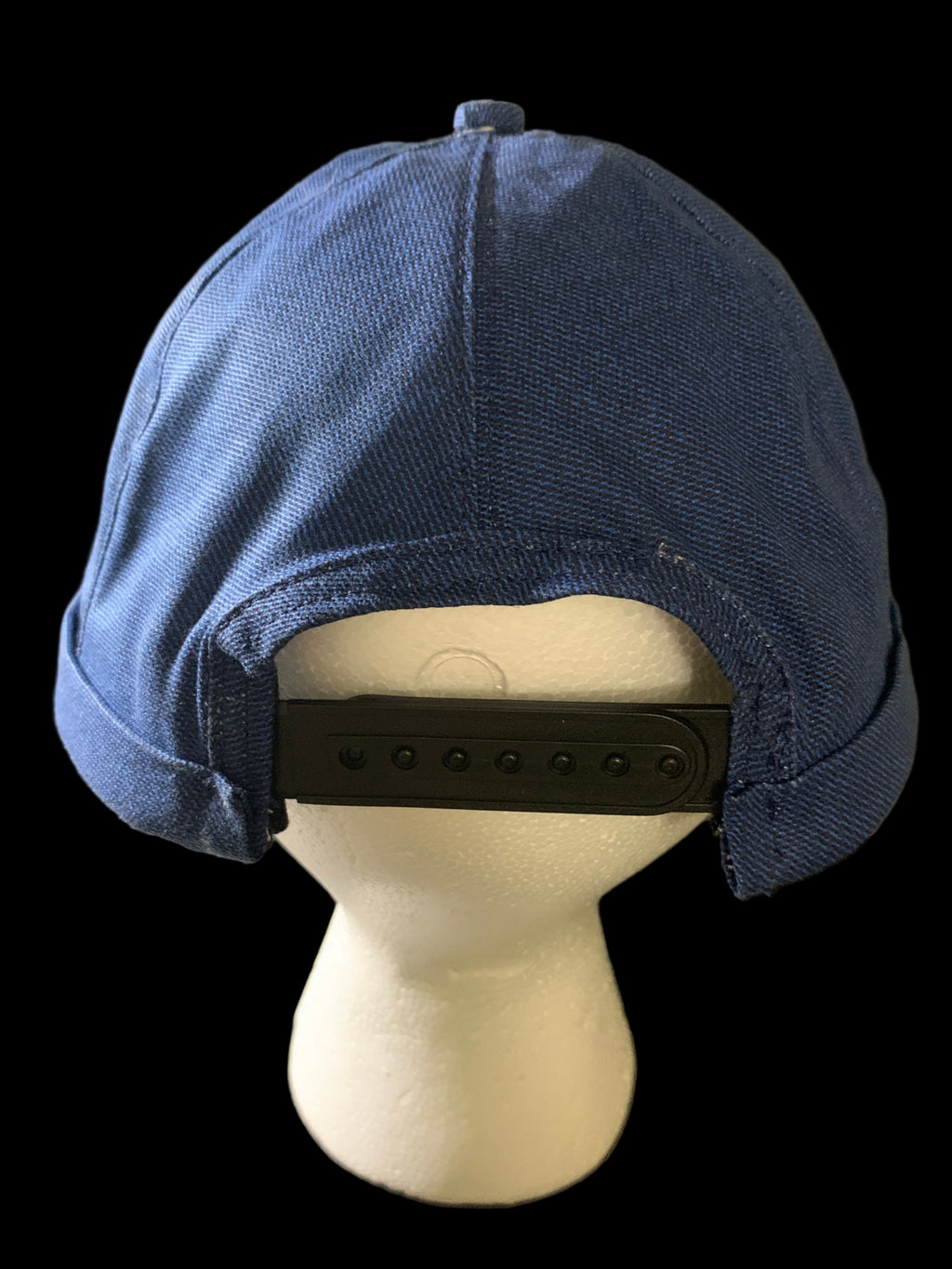 Snap back roll cap hat with a blue botton and blue Jean fabric. Back view. 