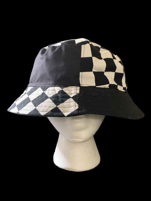 Checkered bucket hat on a mannequin head against a black background. Front view