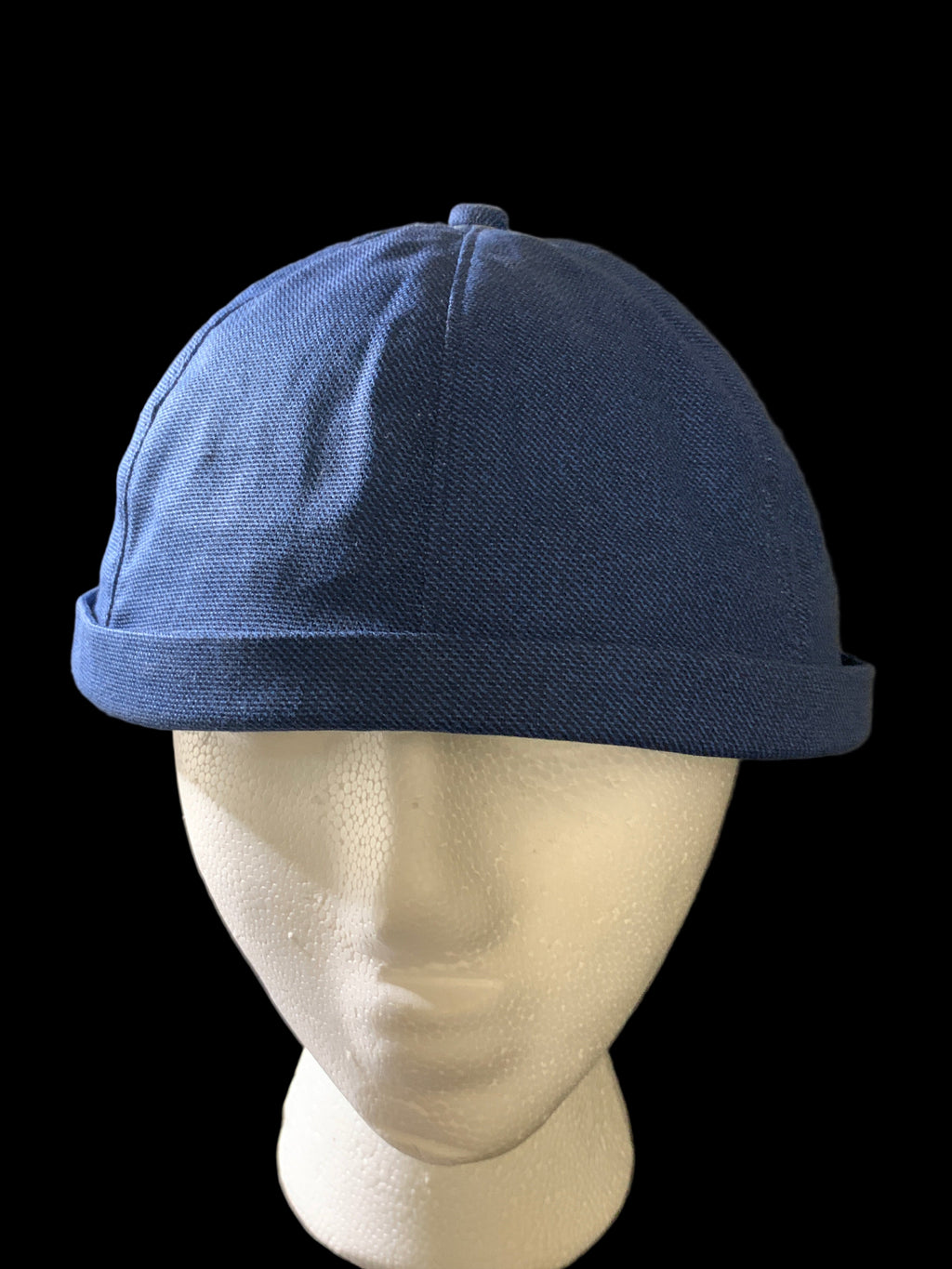 snap back roll cap with a blue button and blue Jean fabric. Front view