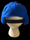 Blue hat with botton, black background with black snaps.